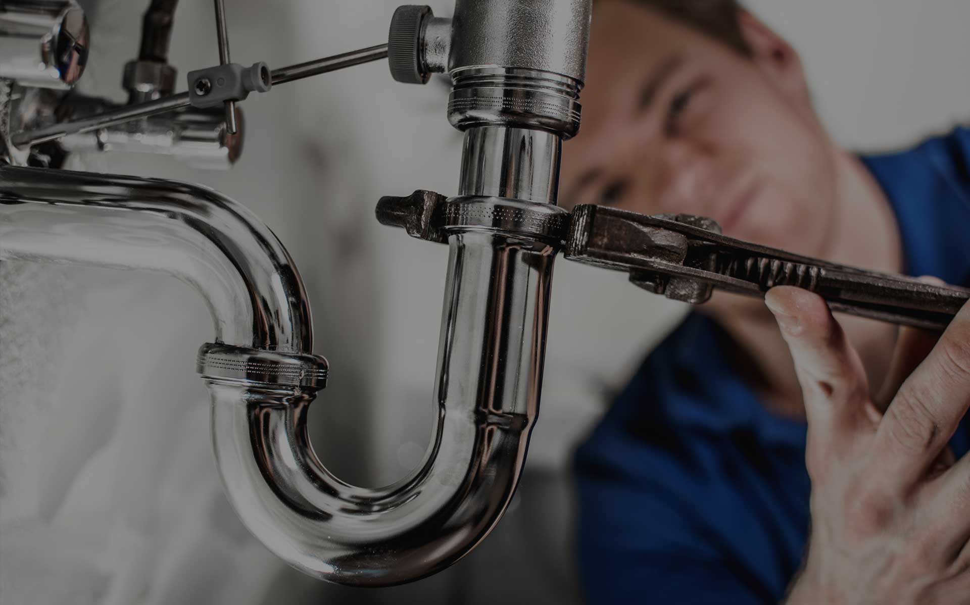 Plumber from Plumbing Company fixing pipe